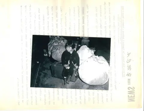 A child with the family’s bundles